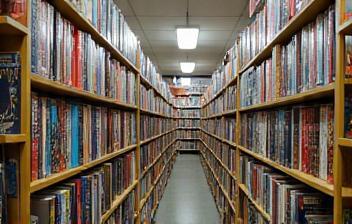 Close-up view of manga spine collection filling several shelves in a bookstore aisle